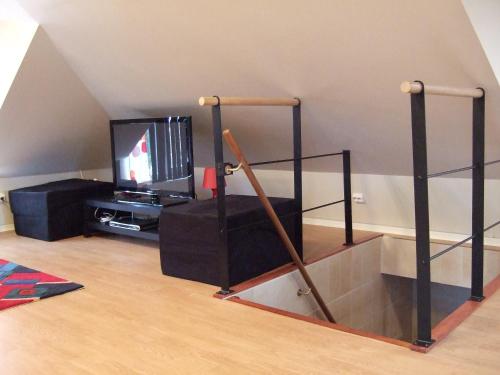 a living room with a tv and a shelf at Honeymoon Seaview Apartment in Helsingborg
