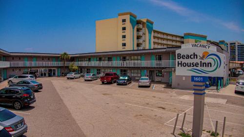 a beach house inn sign in front of a parking lot at Beach House Inn in Daytona Beach