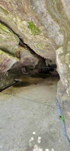 a cave in the side of a large rock at The Rocks Chalets in Takaka