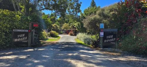 a road with two gates on the side of it at The Rocks Chalets in Takaka