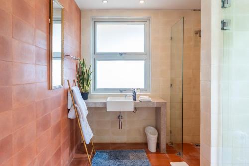 a bathroom with a sink and a window at Hermosa Waves A2 in Playa Hermosa