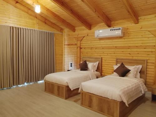 En eller flere senge i et værelse på مزرعة واكواخ ريف الازهر