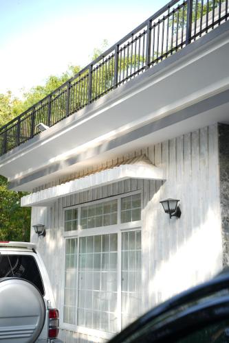 a house with a balcony on top of it at Ariston Suites in Islamabad