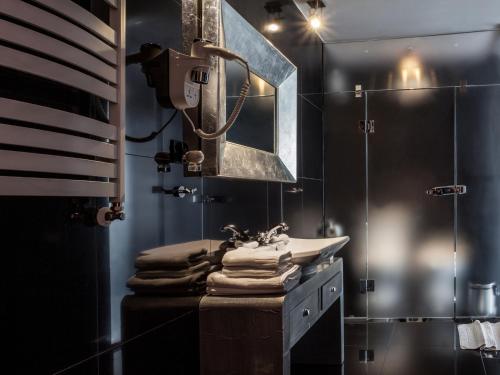 a bathroom with a sink and a mirror at Hotel Betmanowska Main Square Residence Adults Only in Kraków