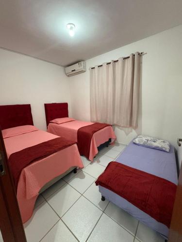 a room with two beds and a window at APT Bela Cintra PRIME 3 km da praia do Aracagy in São Luís
