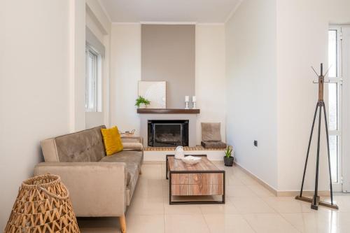 a living room with a couch and a fireplace at Villa Campagna in Kefalos