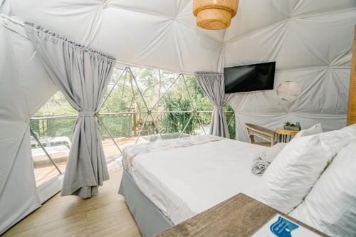 Postel nebo postele na pokoji v ubytování Glamping Tortuga Verde