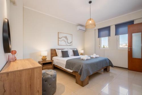 a bedroom with a bed and a tv and windows at Villa Campagna in Kefalos
