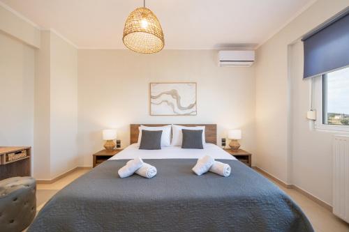 a bedroom with a large bed with two pillows at Villa Campagna in Kefalos