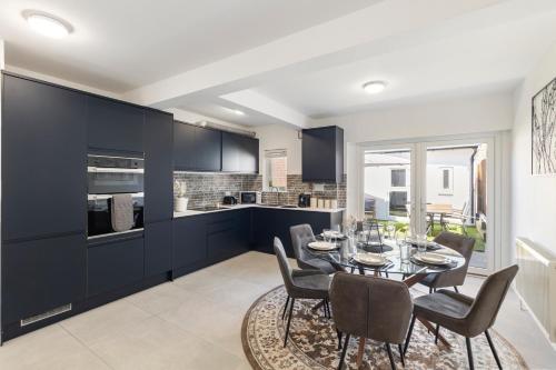 a kitchen and dining room with a table and chairs at Modern Studio Central Location Private Bathroom and shared Kitchen 2 in Edgware