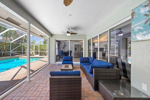 a living room with blue furniture and a swimming pool at Modern 4BR in Central Wellington- Walk to Shops in Wellington