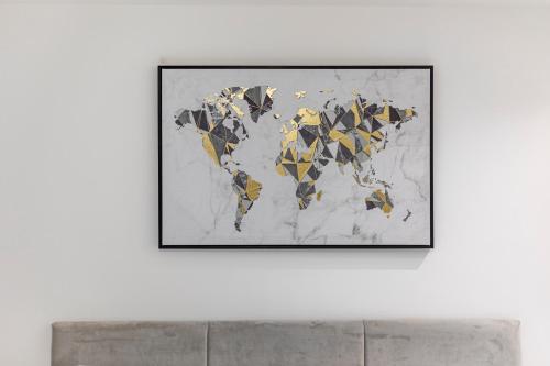 a framed picture of a world map on a white wall at Bespoke Studio 23 Min - C London Private Bathrroom Shared Kitchen 3 in Edgware