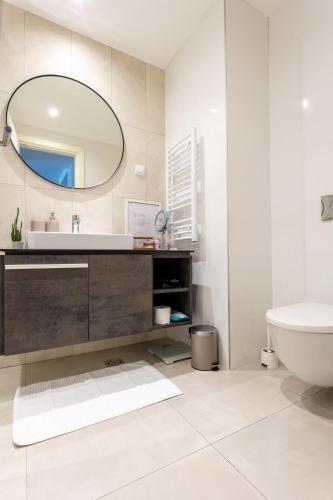 a bathroom with a sink and a mirror at The View Belgrade Waterfront in Belgrade