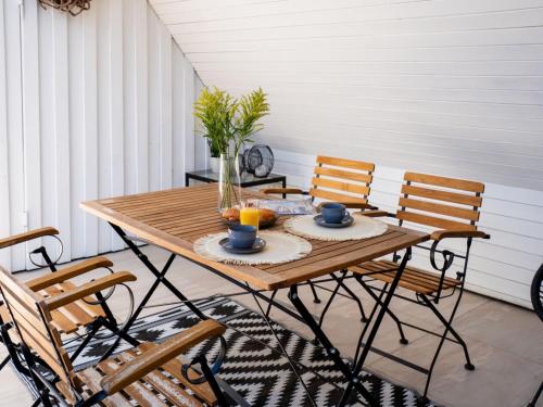 a wooden table with two chairs on a porch at Das Torhaus in Lübeck