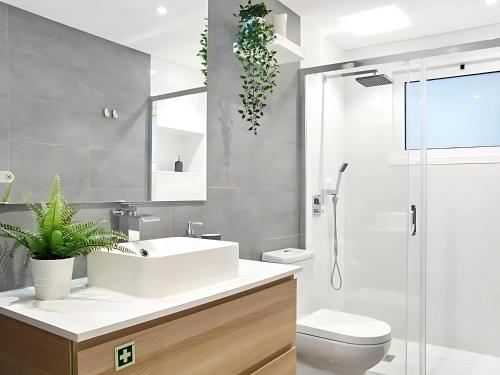 a bathroom with a sink and a toilet and a shower at Alegria 79 - Fabulous 3 Bedroom House in Coimbra