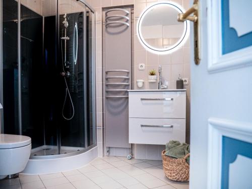a bathroom with a shower and a sink and a mirror at Das Torhaus in Lübeck