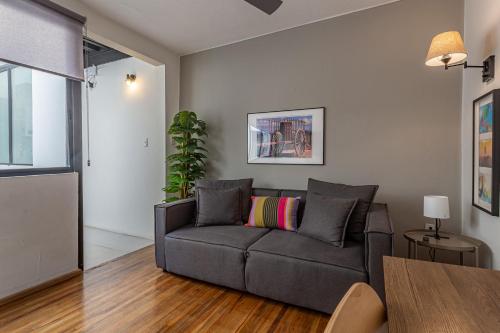 a living room with a couch and a table at Amalli, Refugio Urbano in Mexico City