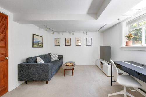 a living room with a couch and a table at Stylish Daylight Basement Apartment- Patio + Grill in Seattle