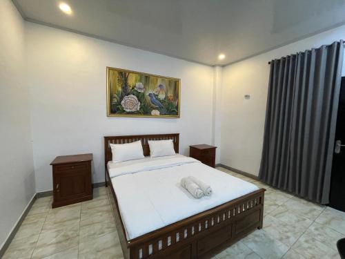 Ένα ή περισσότερα κρεβάτια σε δωμάτιο στο Wella Mas Homestay