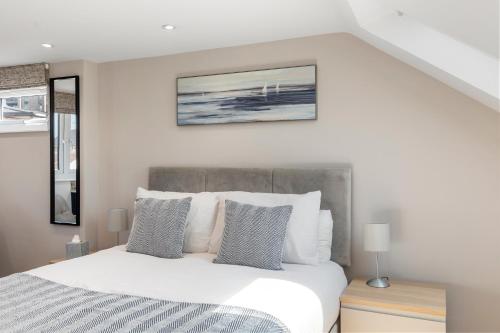 a bedroom with a white bed with pillows at Studio at Tube Station Sleeps 3 Private Bathroom shared Kitchen 4 in Edgware
