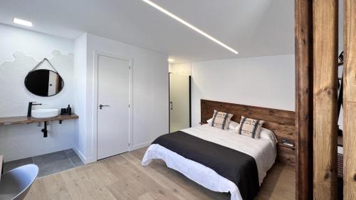 a bedroom with a large bed with a wooden headboard at Calma Suites Tejeda in Tejeda