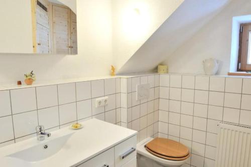 a white bathroom with a toilet and a sink at Retreat in the Bohemian Forest in Schöneben