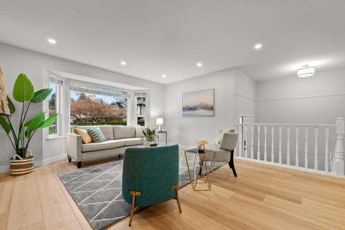 a living room with a couch and a chair at Vancouver Lake City Way Guesthouse 10 min to SkyTrain in Burnaby