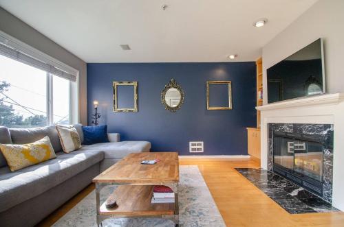 a living room with a couch and a fireplace at Gorgeous Queen Anne Townhouse - Rooftop Deck! in Seattle