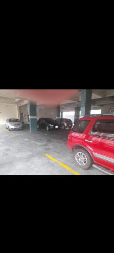 a red car parked in a parking garage at Espaço imigrantes in Praia Grande