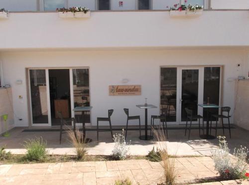 a group of tables and chairs outside of a building at L'Amarena Garden House in Matera
