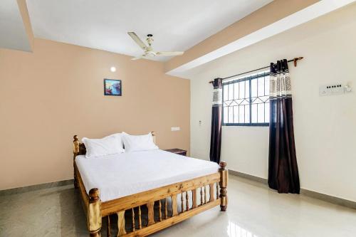 a bedroom with a bed and a window at Hotel O On The Rocks in Goa