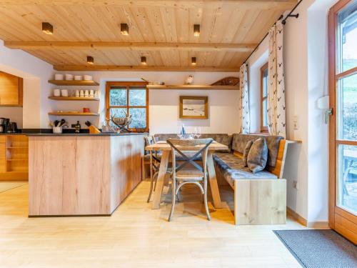 a kitchen and living room with a table and chairs at Spykerhütte in Rauris