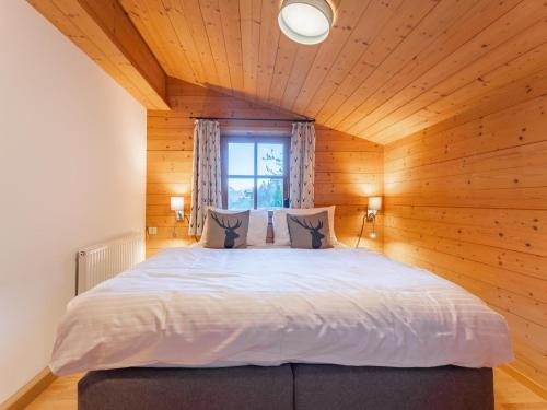 a bedroom with a large bed in a wooden room at Spykerhütte in Rauris