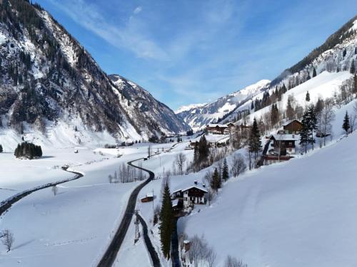 a village in the mountains covered in snow at Spykerhütte in Rauris