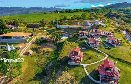 an aerial view of a house on a hill at cabañas campestres buena vista in Paicol