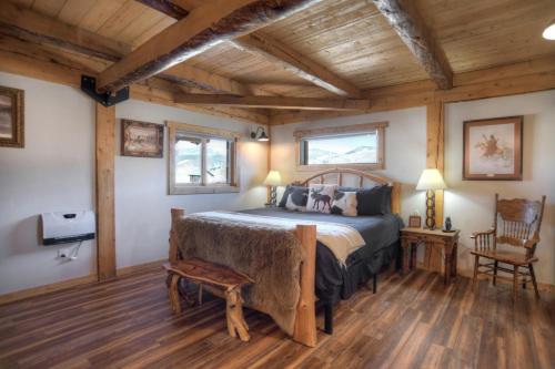 a bedroom with a bed and a wooden ceiling at Homestake Cabin in Creede