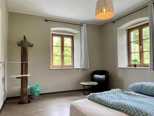 a bedroom with a bed and a cross on the wall at Residenz Aichwaldsee in Unteraichwald
