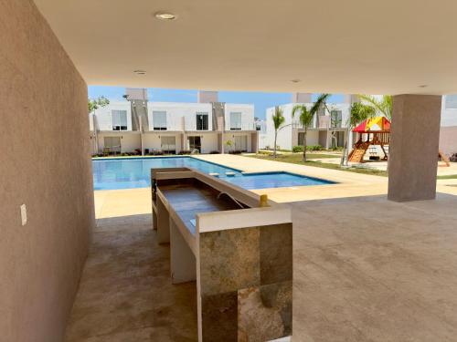 a house with a swimming pool and a house at Linda casa frente a alberca en Playa del Carmen in Playa del Carmen