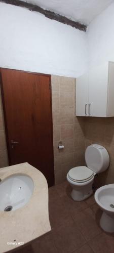 a bathroom with a toilet and a sink at La morada del monte in Yerba Buena