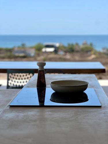 a bowl and a bottle sitting on a table at Casa Amarliz in La Majahua