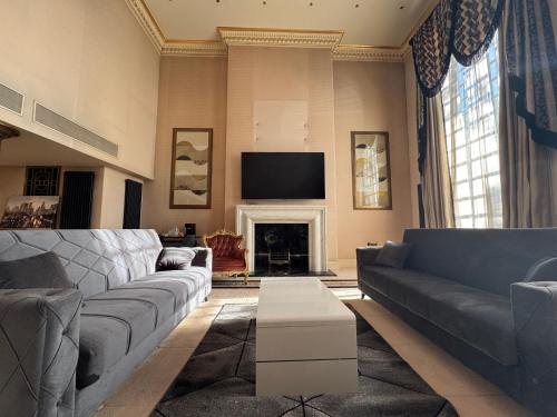 a living room with a couch and a fireplace at The Bishop in London