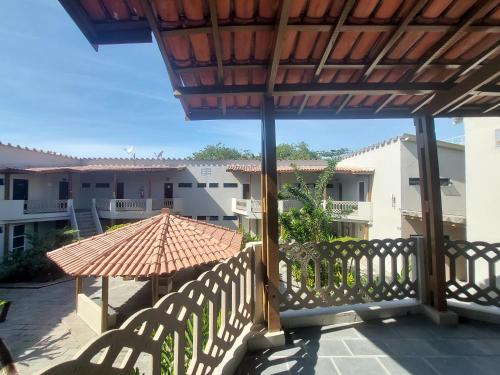 a balcony with an umbrella and some buildings at Apartamento Ubatuba 150m do mar Maranduba in Ubatuba