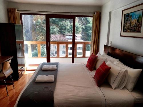 Postel nebo postele na pokoji v ubytování El Quetzal MachuPicchu