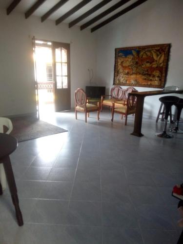 a living room with a table and chairs and a couch at Hostal barajas in Jardin