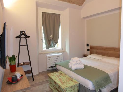 a bedroom with a bed and a ladder and a window at Agua B'n'B in Grosseto