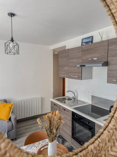a kitchen with a sink and a stove at Le Dunant - Rocade - Tram in Grenoble