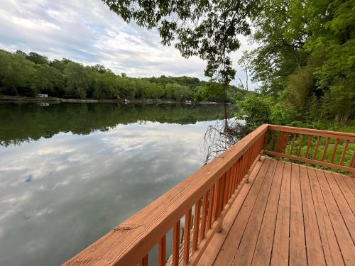 a wooden dock with a view of a lake at Rivers Edge - On the River, Breathtaking views! in Front Royal