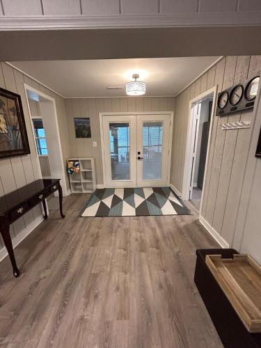 a living room with a piano and a checkered floor at Rivers Edge - On the River, Breathtaking views! in Front Royal