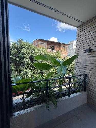a balcony with a view of plants and buildings at NUEVO apartamento en Apartado, aire acondicionado in Apartadó