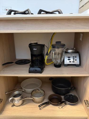 a shelf with kitchen utensils and a blender at NUEVO apartamento en Apartado, aire acondicionado in Apartadó
